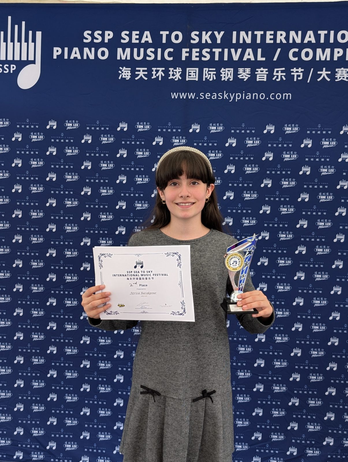 Student holding a second place certificate and trophy at the Sea to Sky International Piano Festival 2026